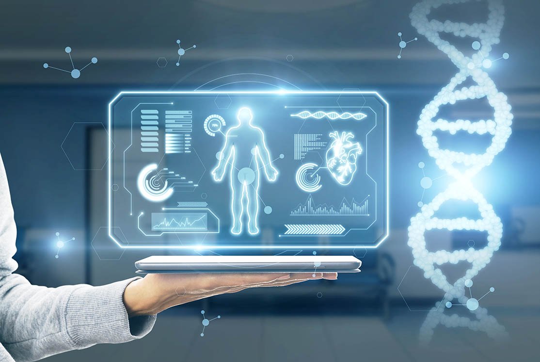 A holographic display of the human body held above an open laptop