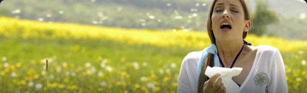 A woman outdoors holding a tissue