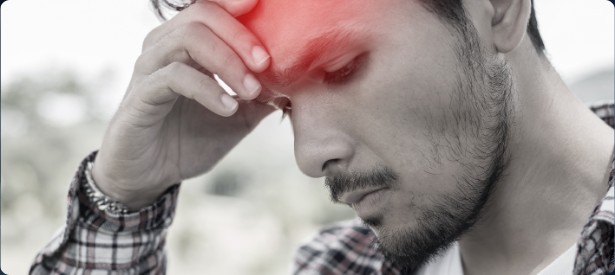 A man holding his forehead