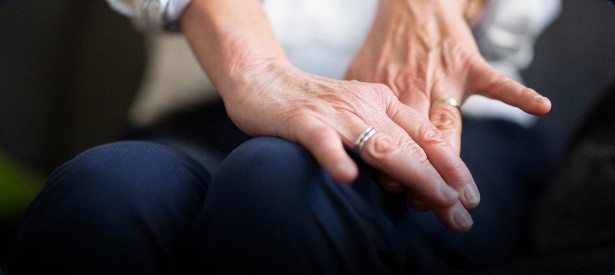 Close view of hands resting on a lap
